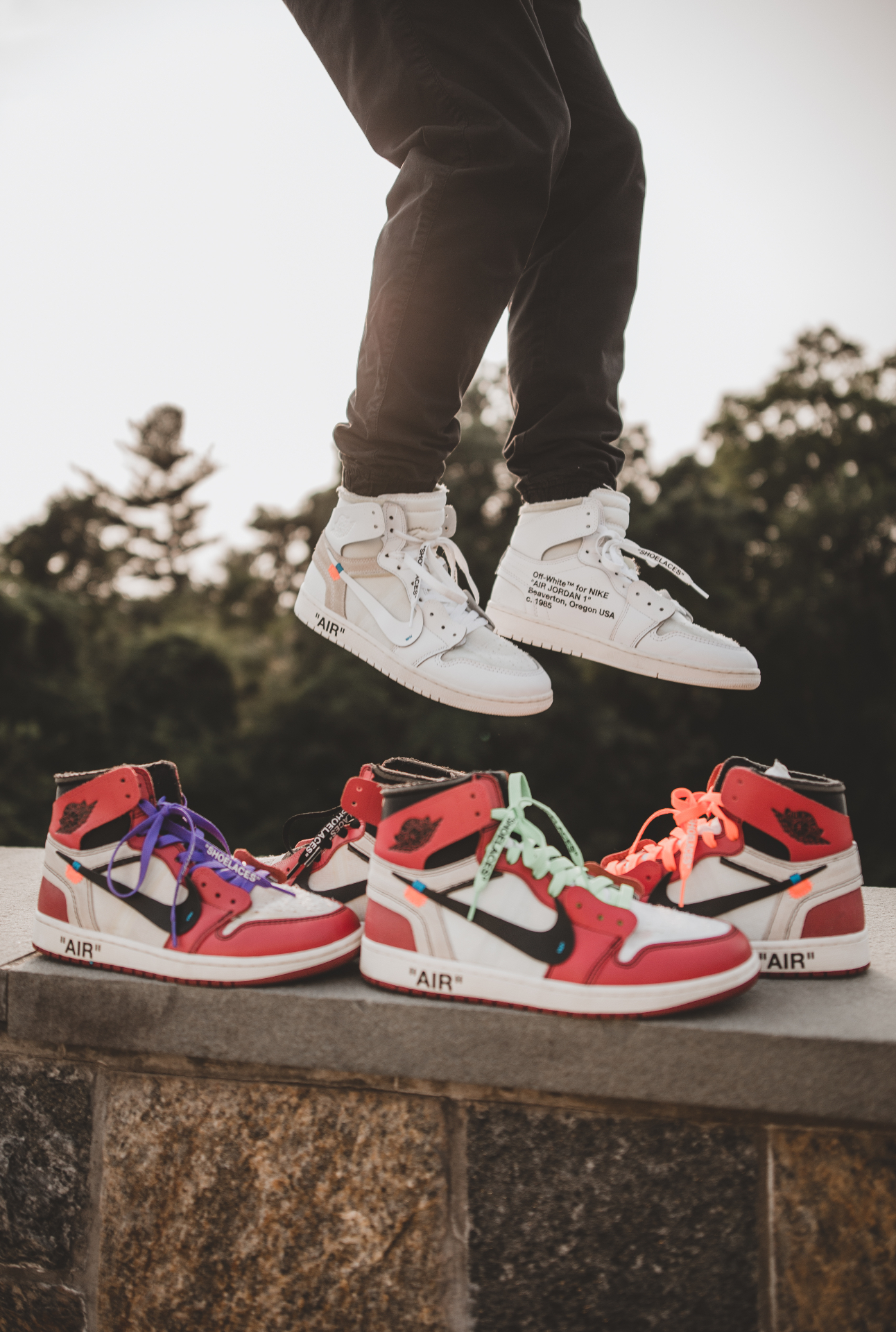 Jumping above a row of sneakers